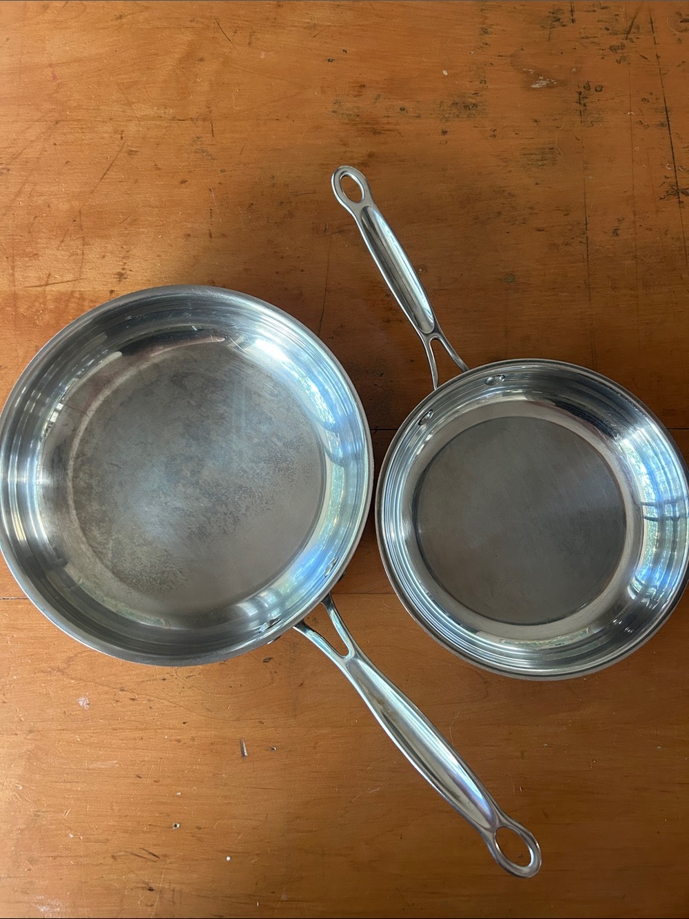 set Cuisinart Chef's Classic stainless steel skillets riveted handles.